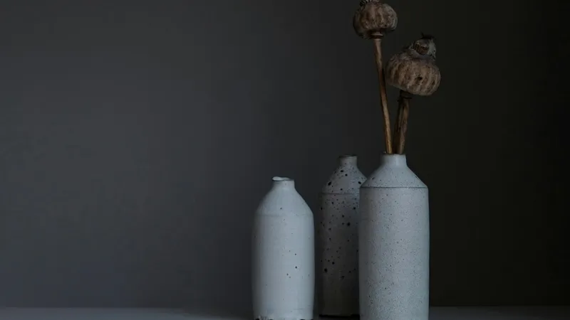 Ceramic artist working at pottery wheel in bright studio